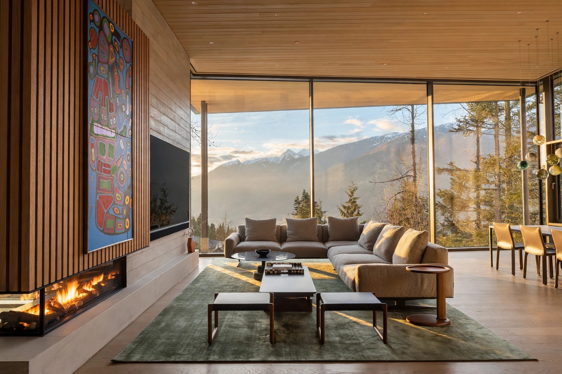Kadenwood living room with a stone fireplace and large colorful painting