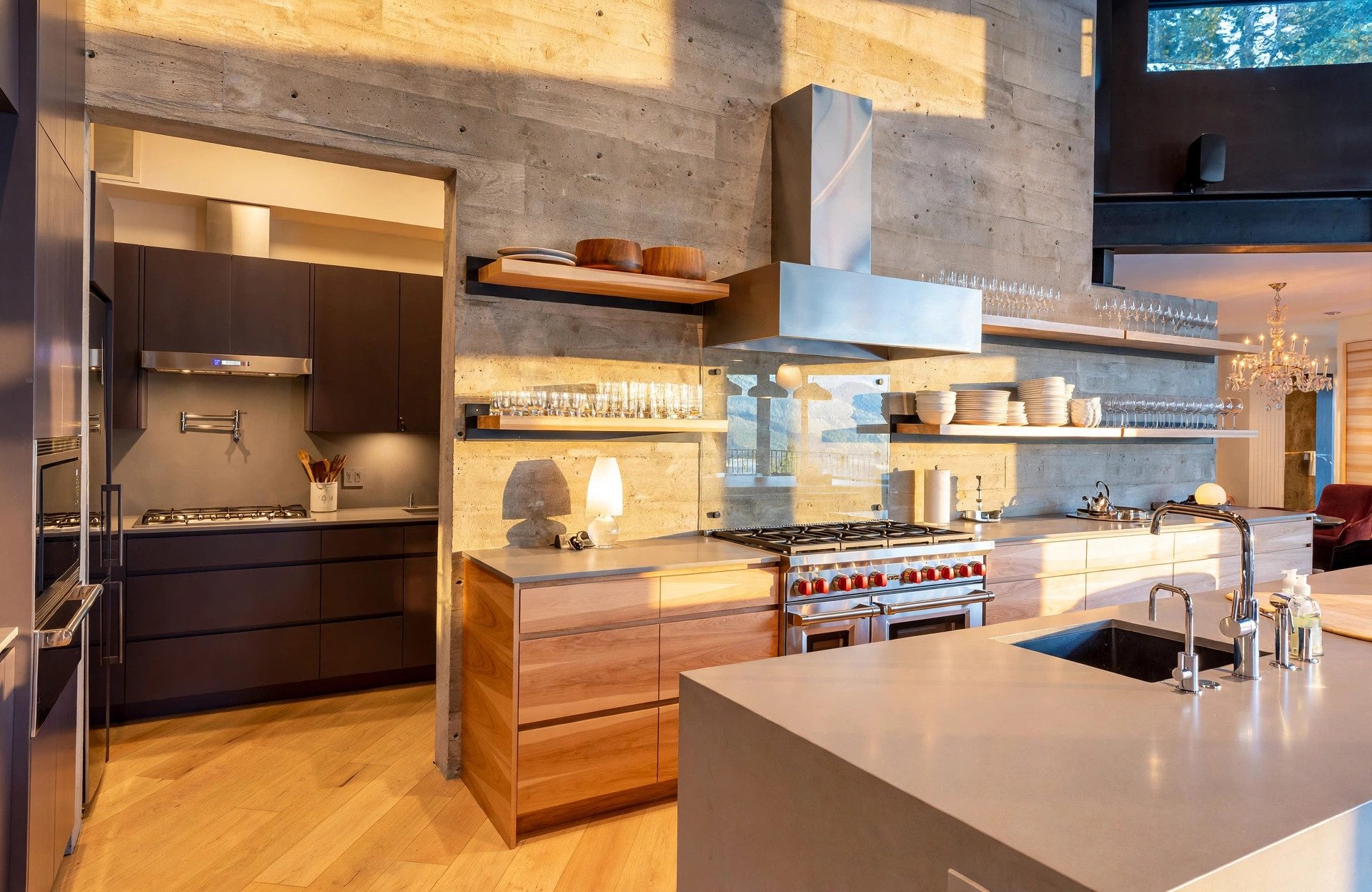 Custom kitchen with board-formed concrete, walnut cabinetry, and professional range