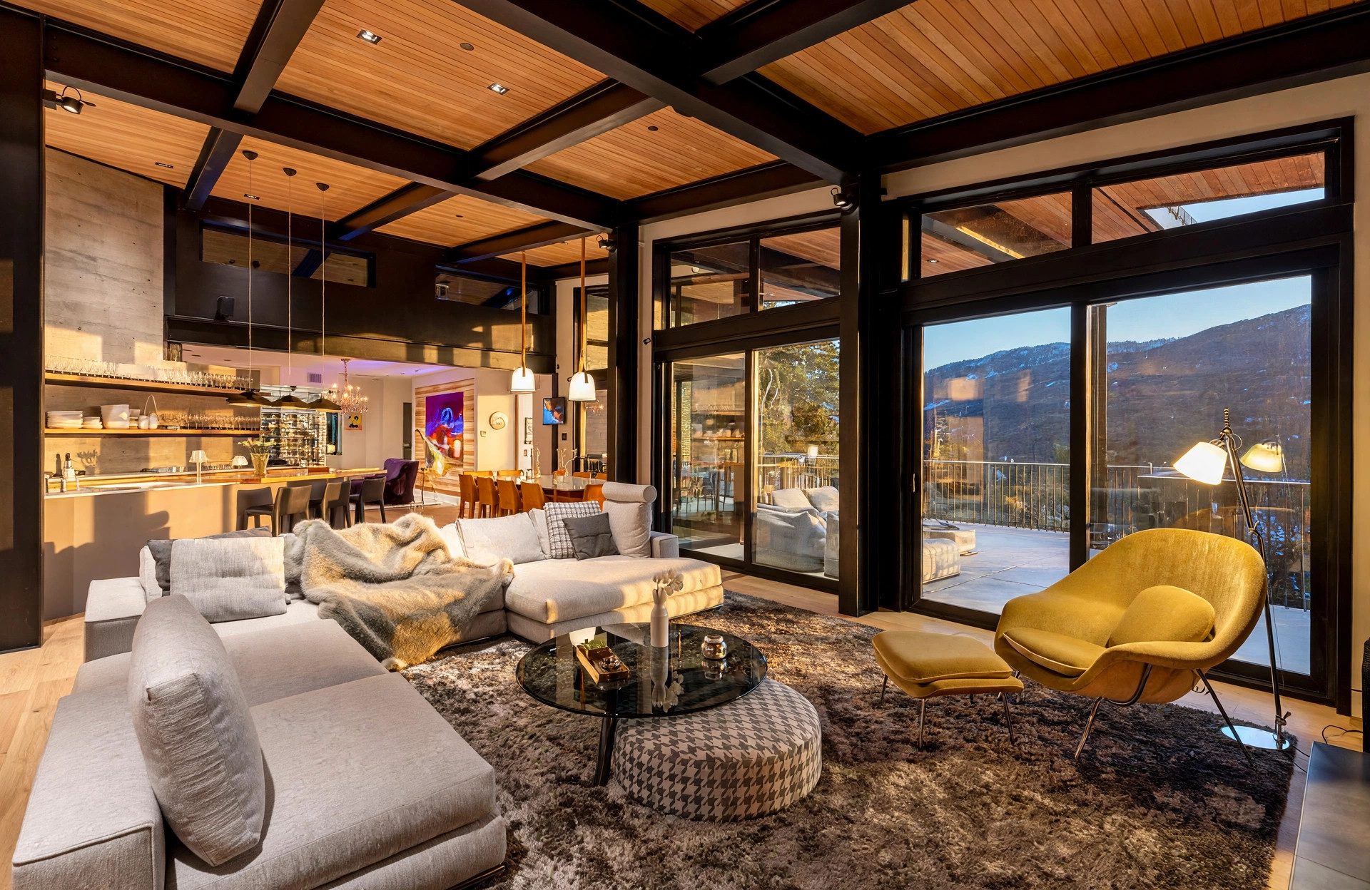 Open living space with timber ceiling, mountain views, and adjoining kitchen