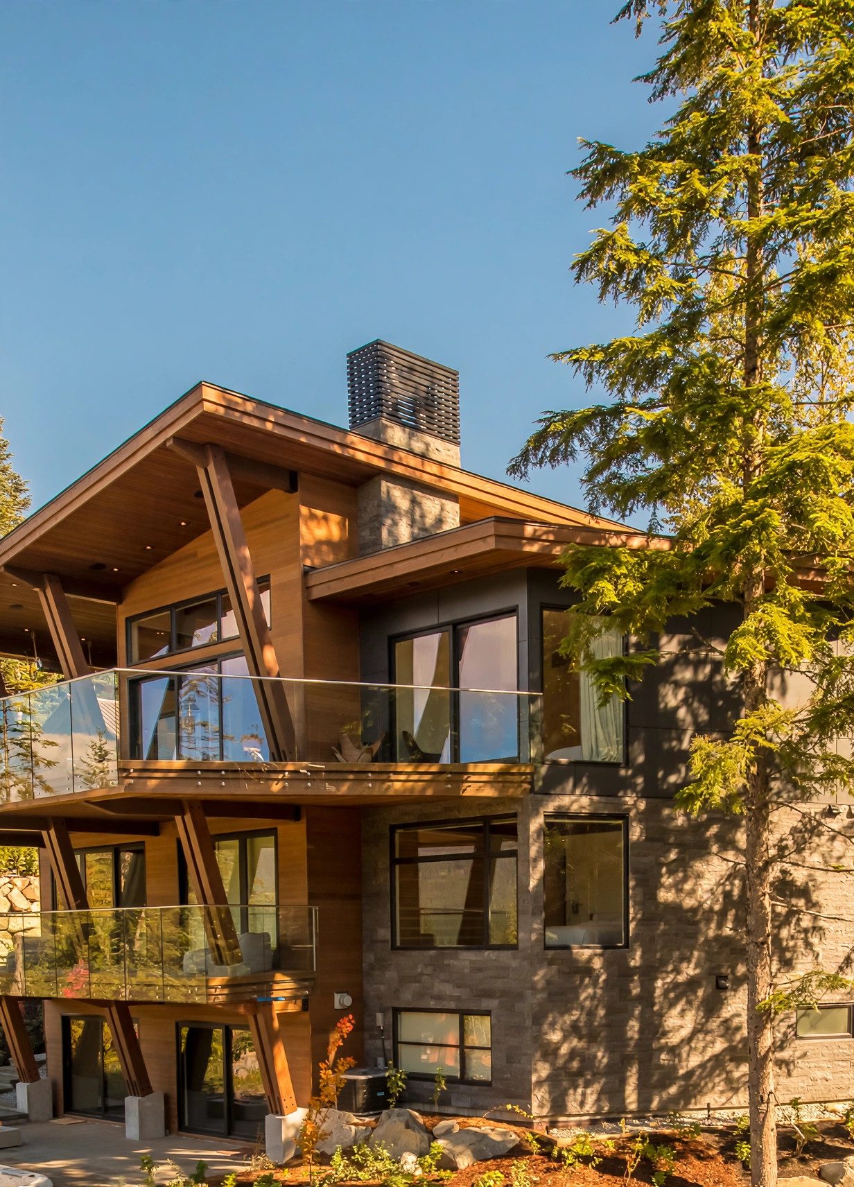 Timber and stone mountain residence framed by mature evergreens